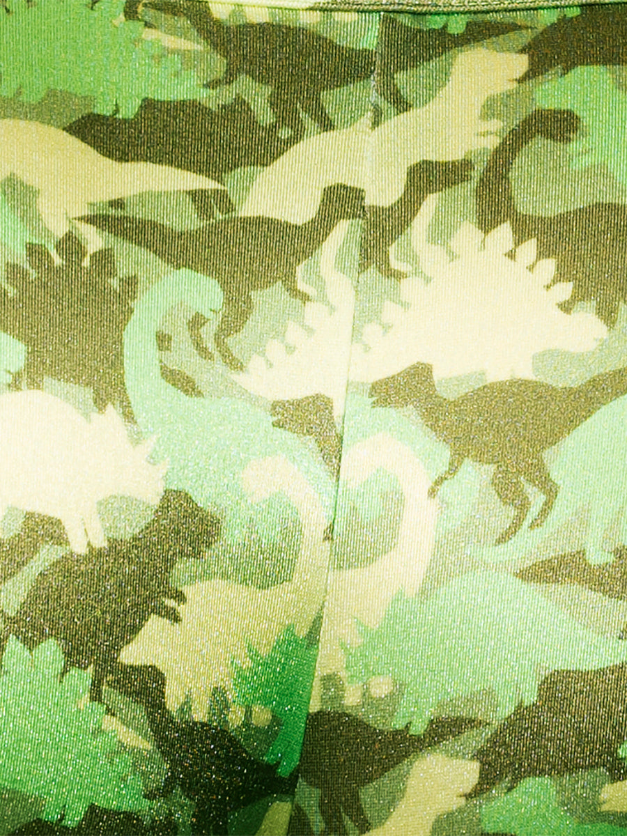 Closeup view of green fabric with a camo pattern made from dinosaur shapes