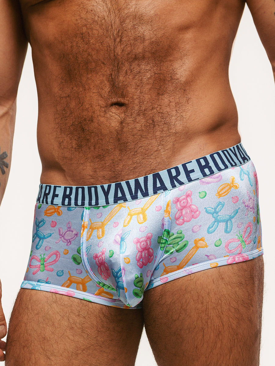Closeup view of a man wearing light blue satin boxers with Body Aware branded waistband