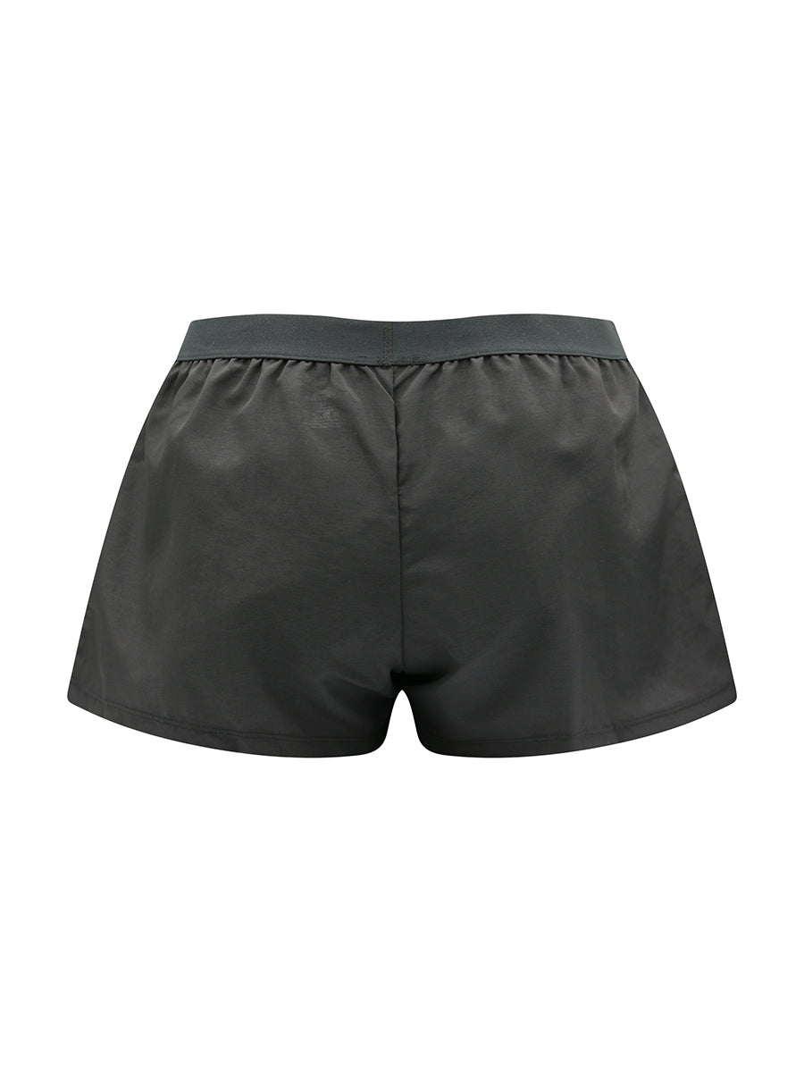 Rear view of black athletic shorts on a white background.