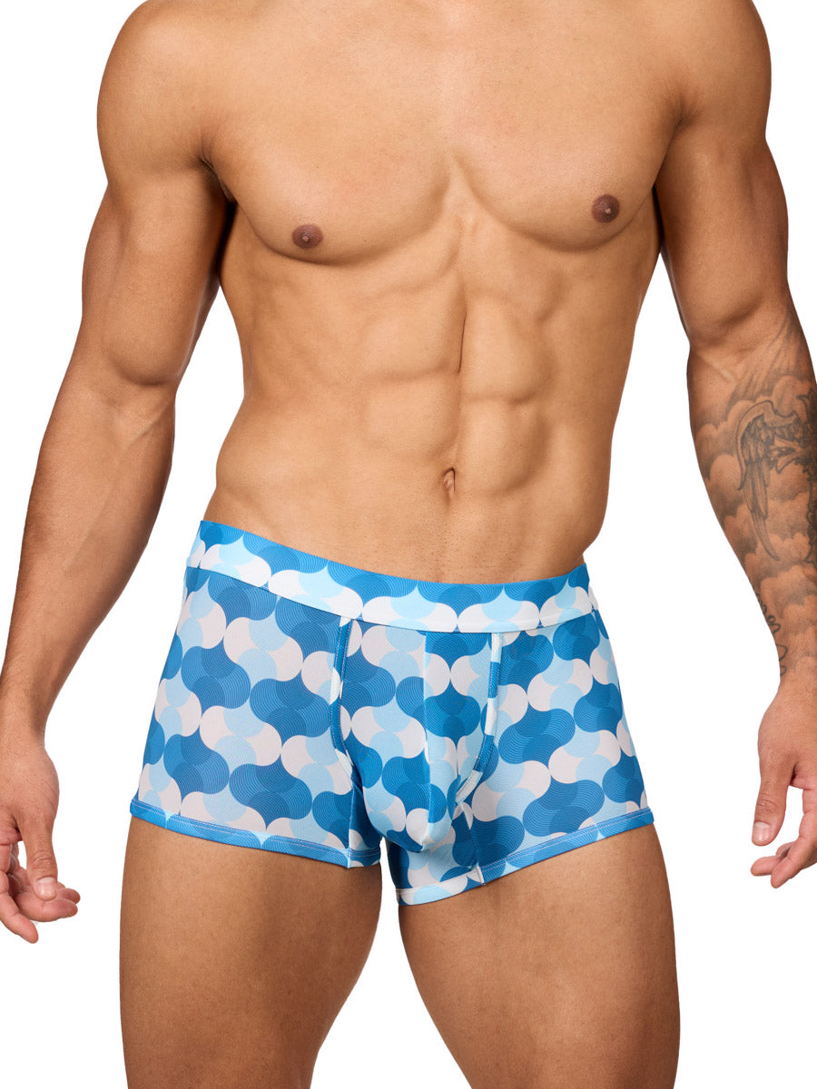 Front view of a male model wearing Body Aware men's boxer briefs in a blue and white wave patterned print, featuring a contoured pouch.