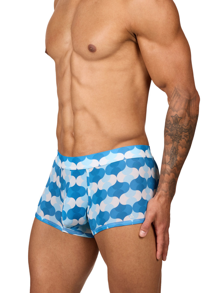 Front side view of a male model wearing Body Aware men's boxer briefs in a blue and white wave patterned print, featuring a contoured pouch.
