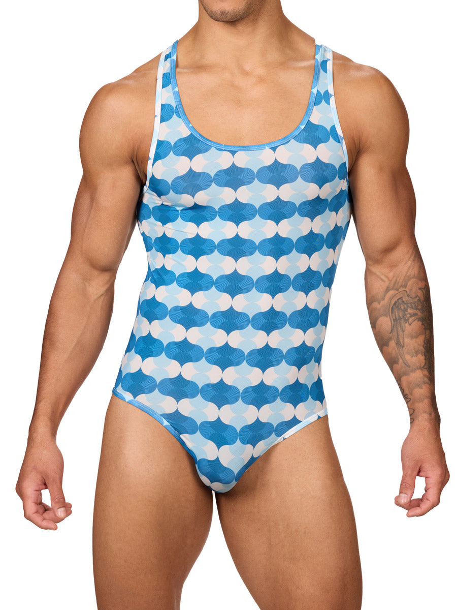 Front view of a male model wearing a Body Aware men's bodysuit in a blue and white wave patterned print, featuring racerback shoulder straps.
