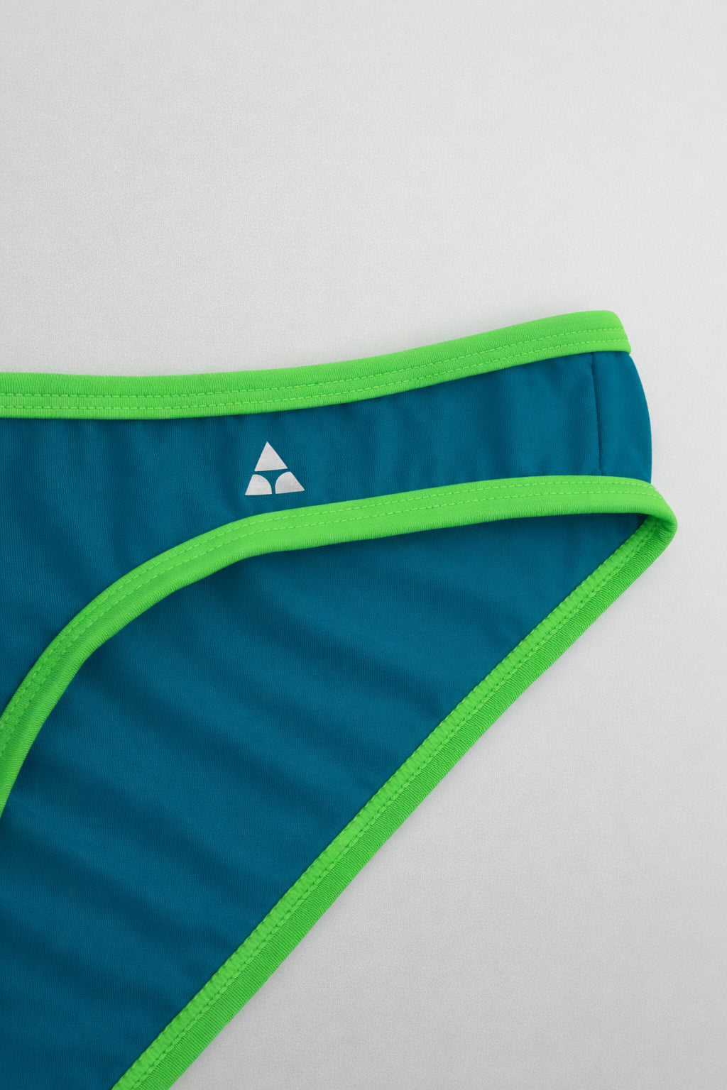 Blue men's underwear with green trim on a white background