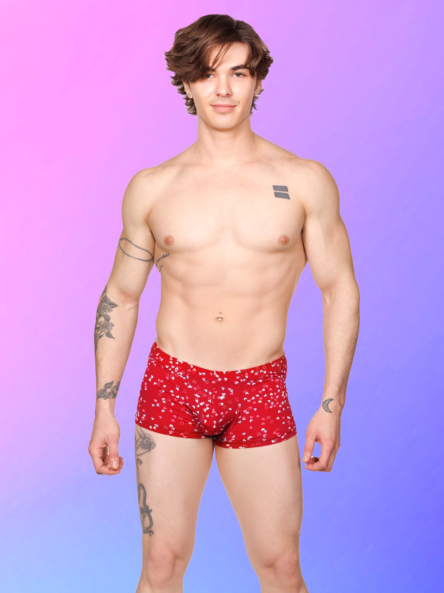 Front view of a male model wearing red Body Aware boxer shorts with a multicolor heart pattern