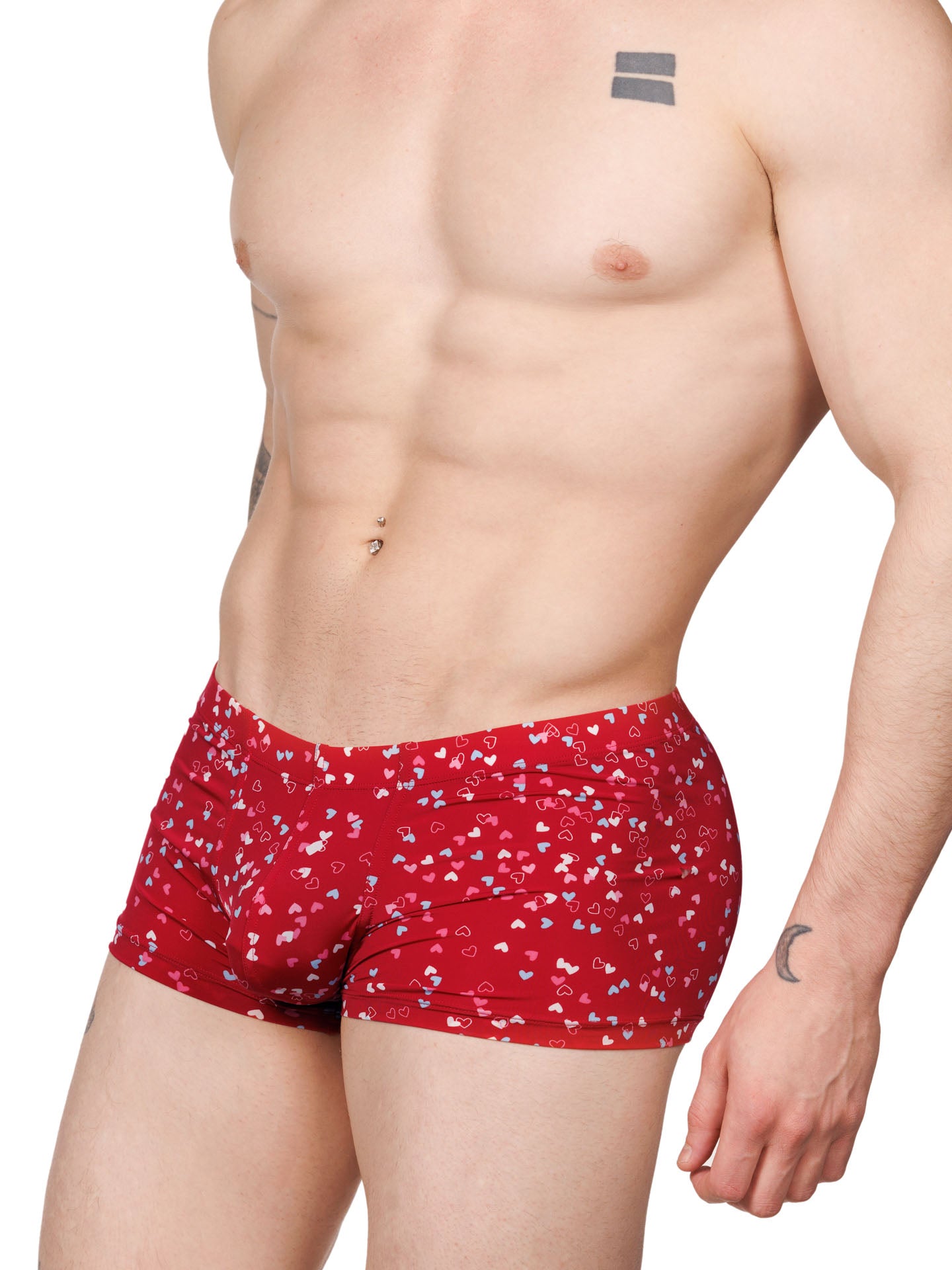 Side view of a male model wearing red Body Aware boxer shorts with a multicolor heart pattern