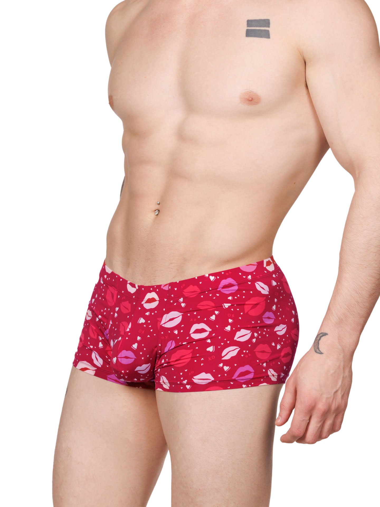 Side view of a male model wearing red Body Aware boxer shorts with a lipstick kiss pattern