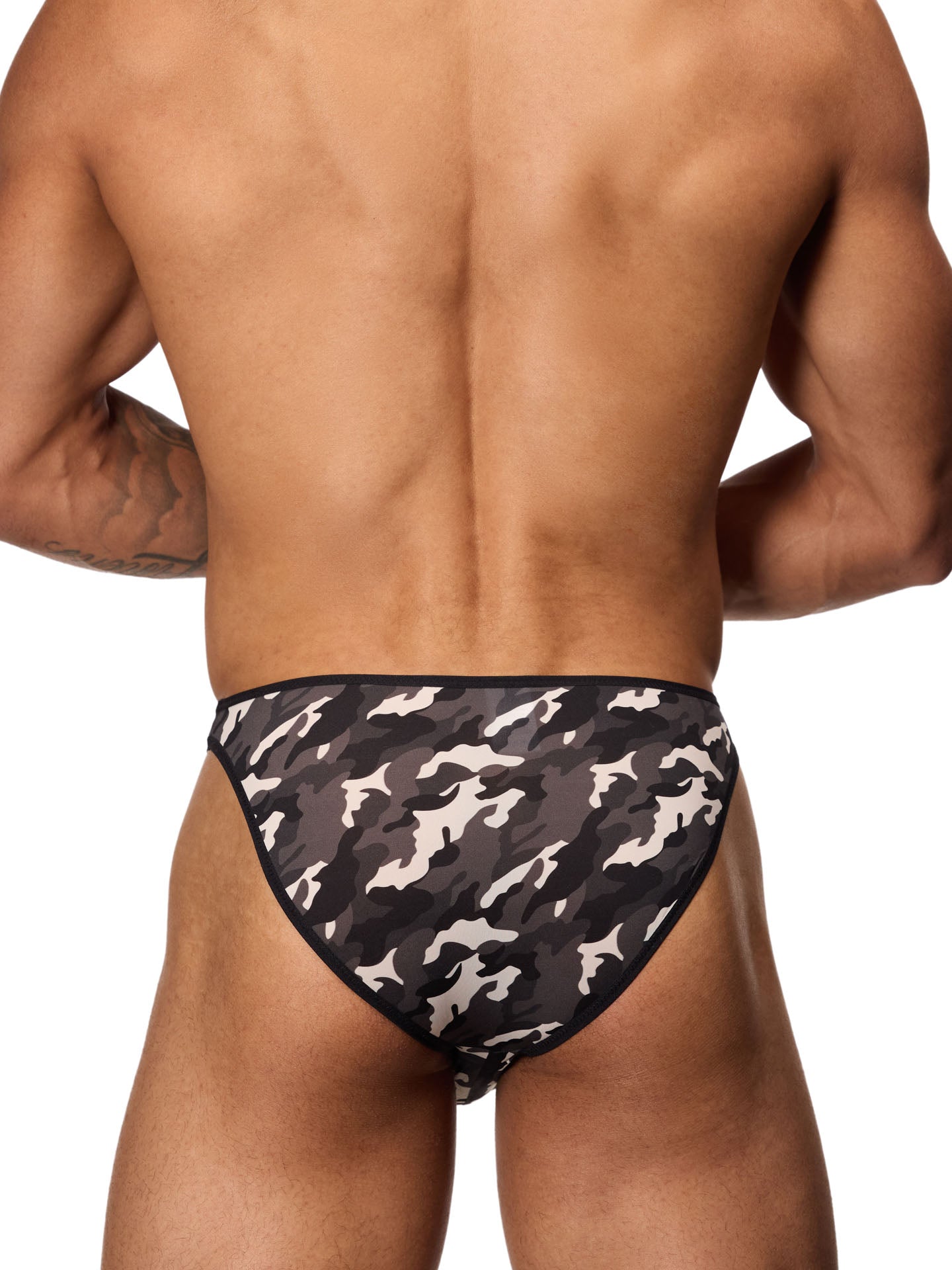 Back view of a male model wearing a black and white camouflage brief with black binding