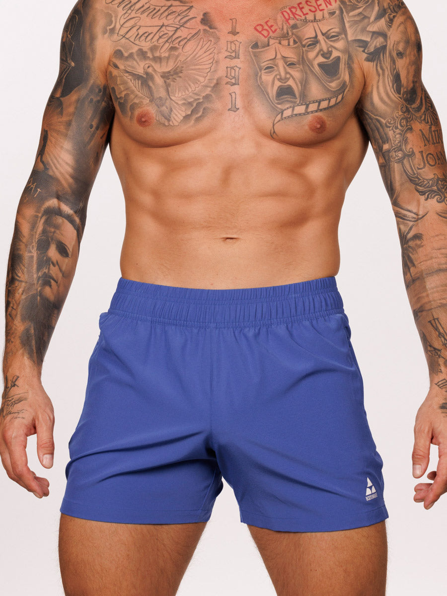 Front view of a male model wearing blue Body Aware athletic shorts