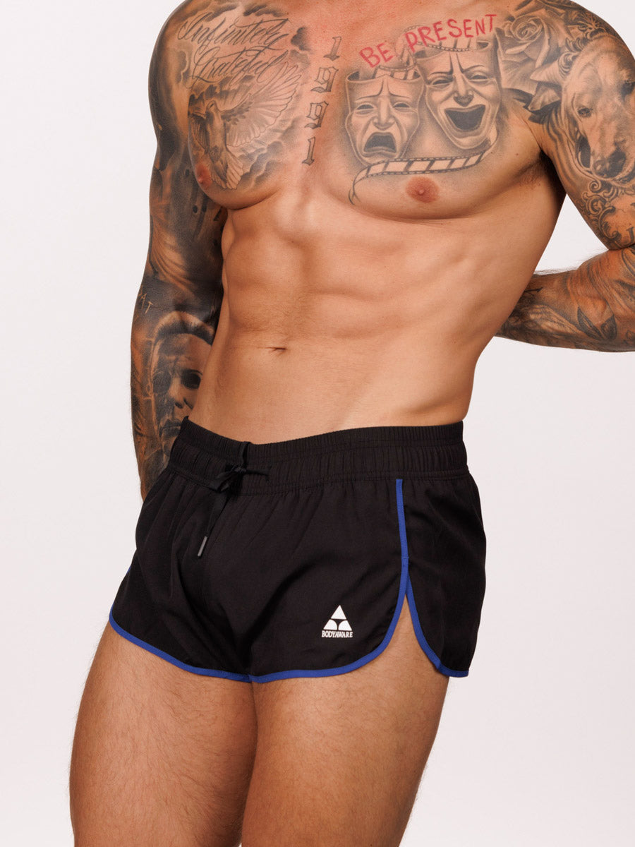 Front view of a male model wearing black Body Aware running shorts