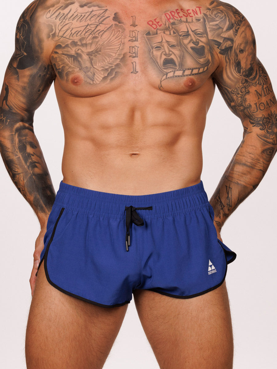 Front view of a male model wearing blue Body Aware side split shorts