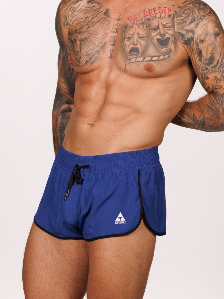 Front view of a male model wearing blue Body Aware side split shorts