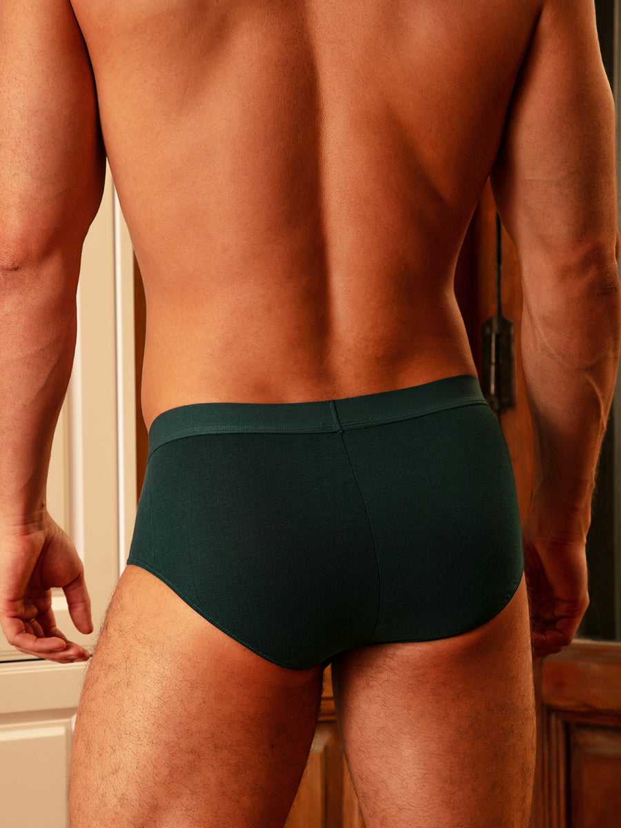 Closeup rear view of a man wearing teal green Body Aware briefs.