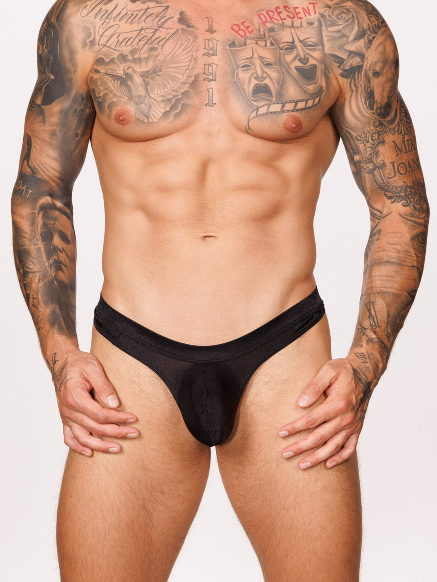 Front view of male model wearing a black Body Aware thong