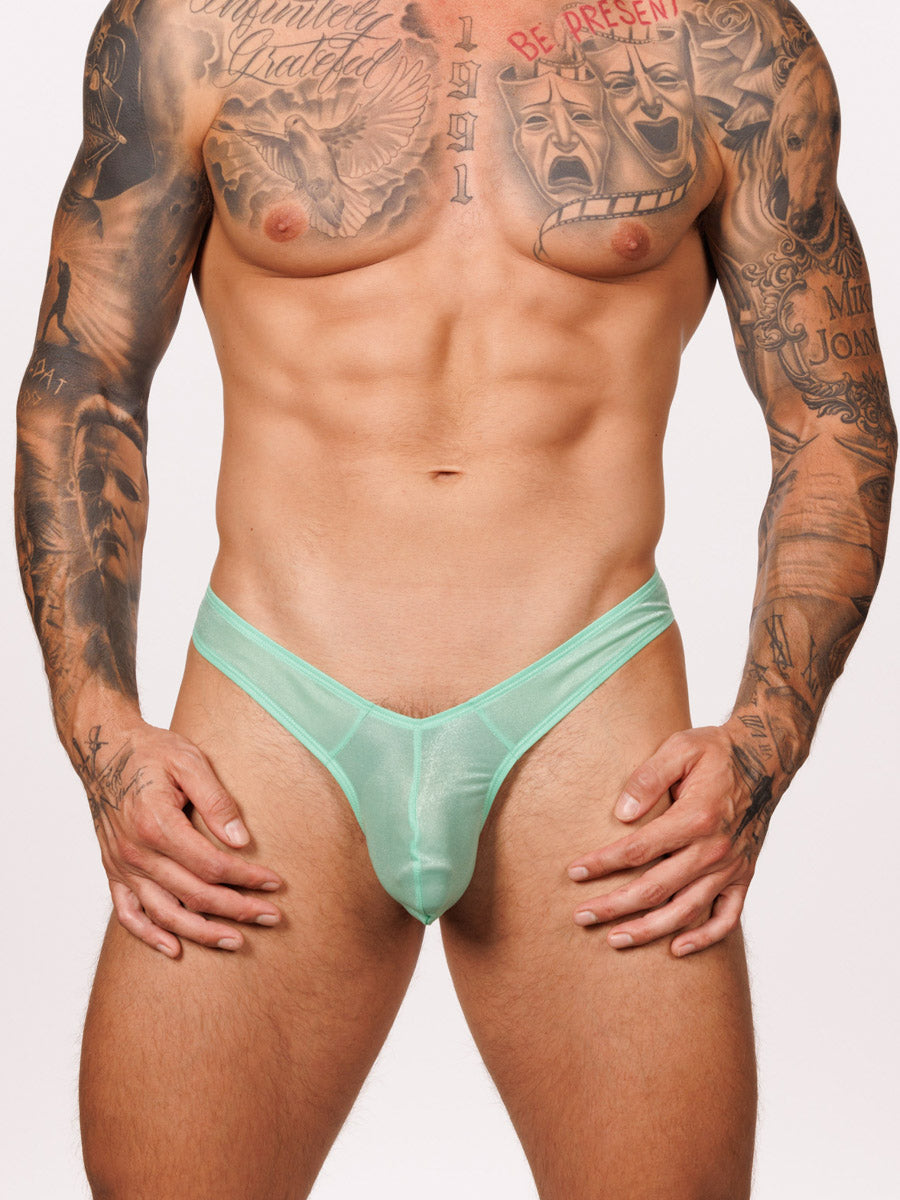 Front view of a male model wearing a green Body Aware thong