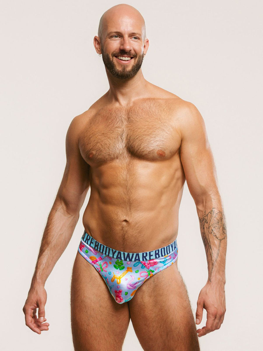 A man wearing a light blue satin thong with a Body Aware branded waistband