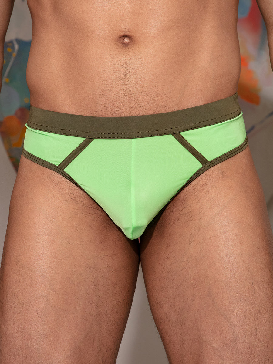Closeup front view of a man wearing a lime green thong with olive trim.