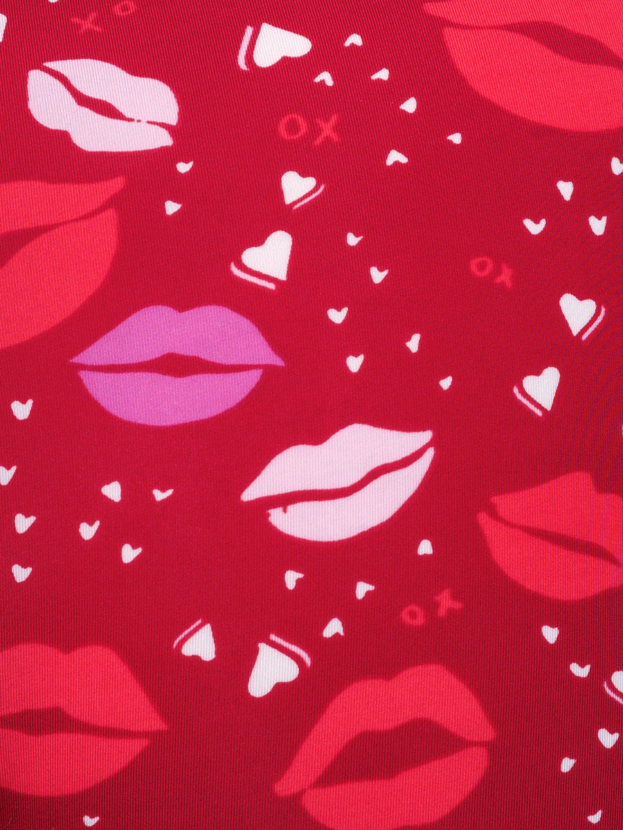 Closeup view of red fabric with a lipstick kiss pattern