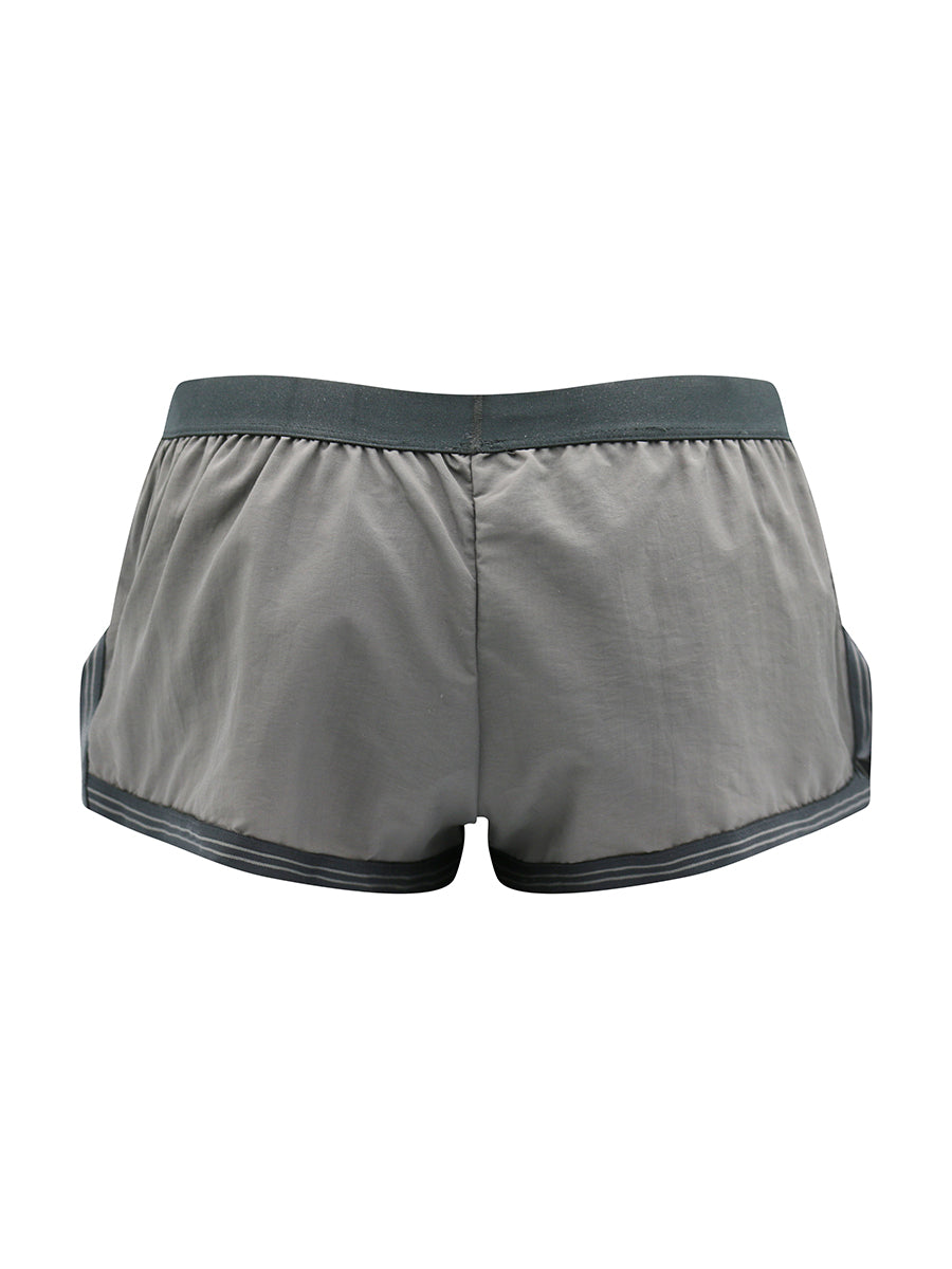 Rear view of grey athletic shorts with black waistband on a white background