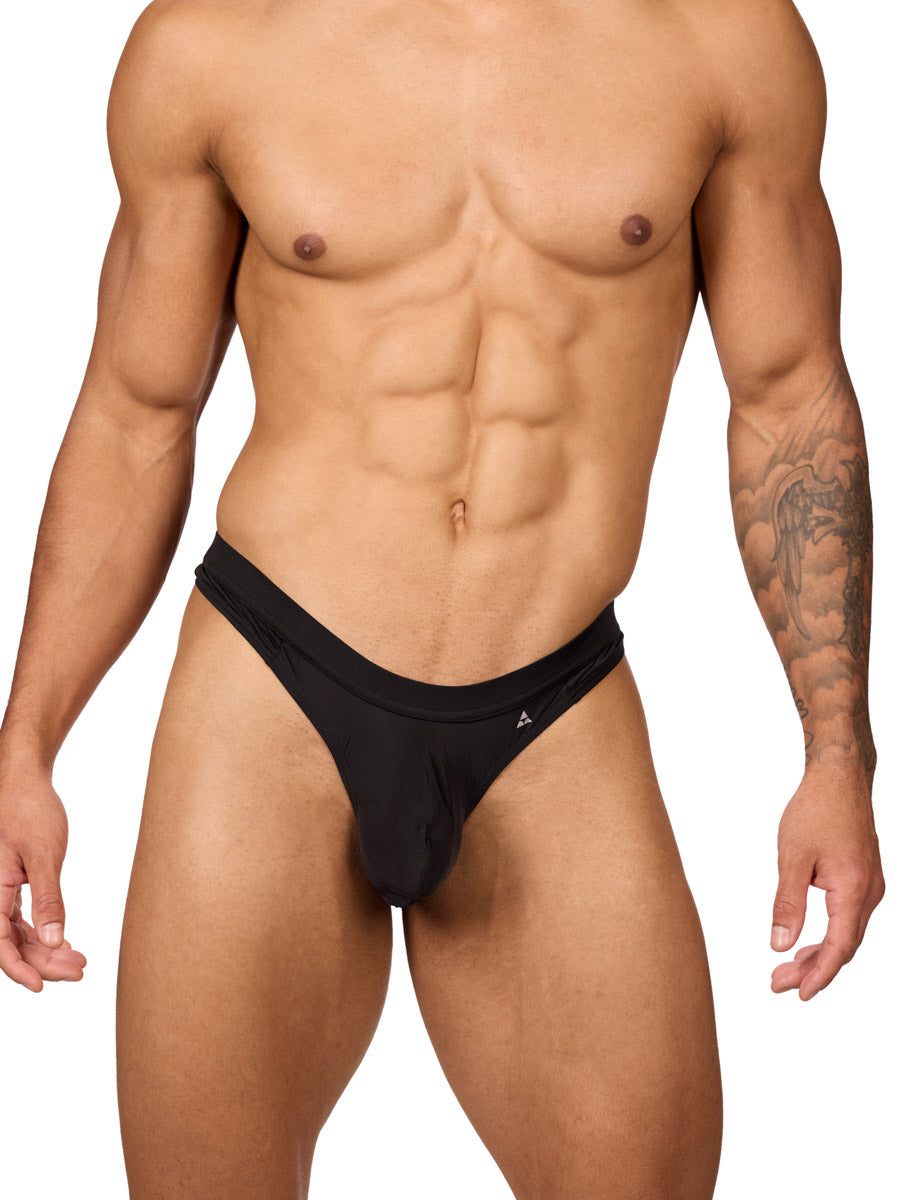 Front view of a muscular male model wearing a black Body Aware thong with matching waistband