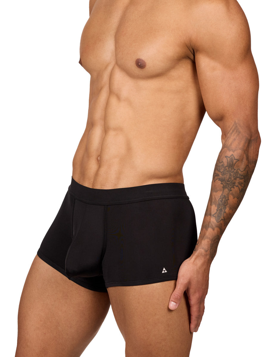 Side view of a muscular male model wearing black Body Aware boxer shorts