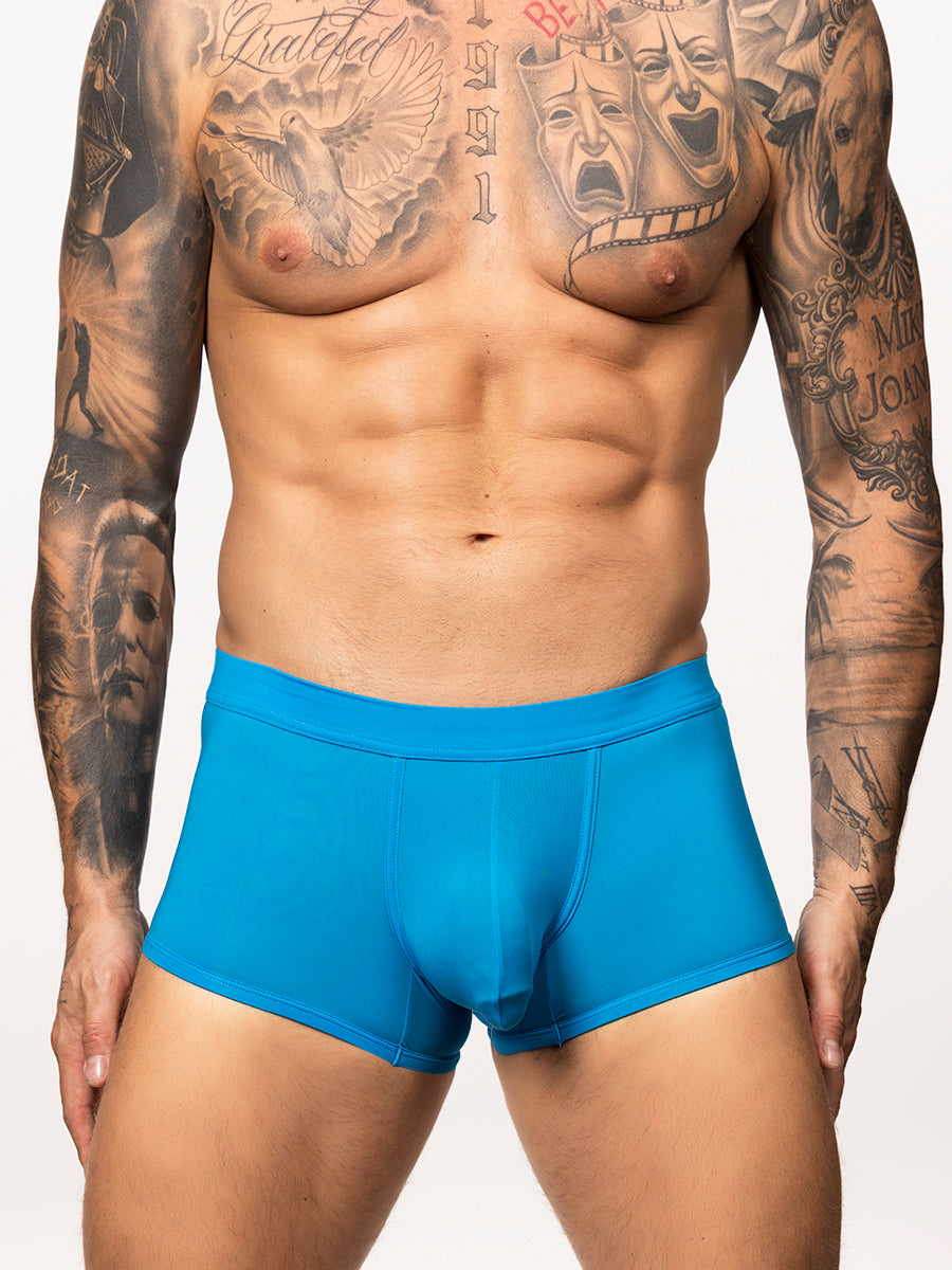 Front view of a man wearing a bright blue Body Aware glow uplift boxer