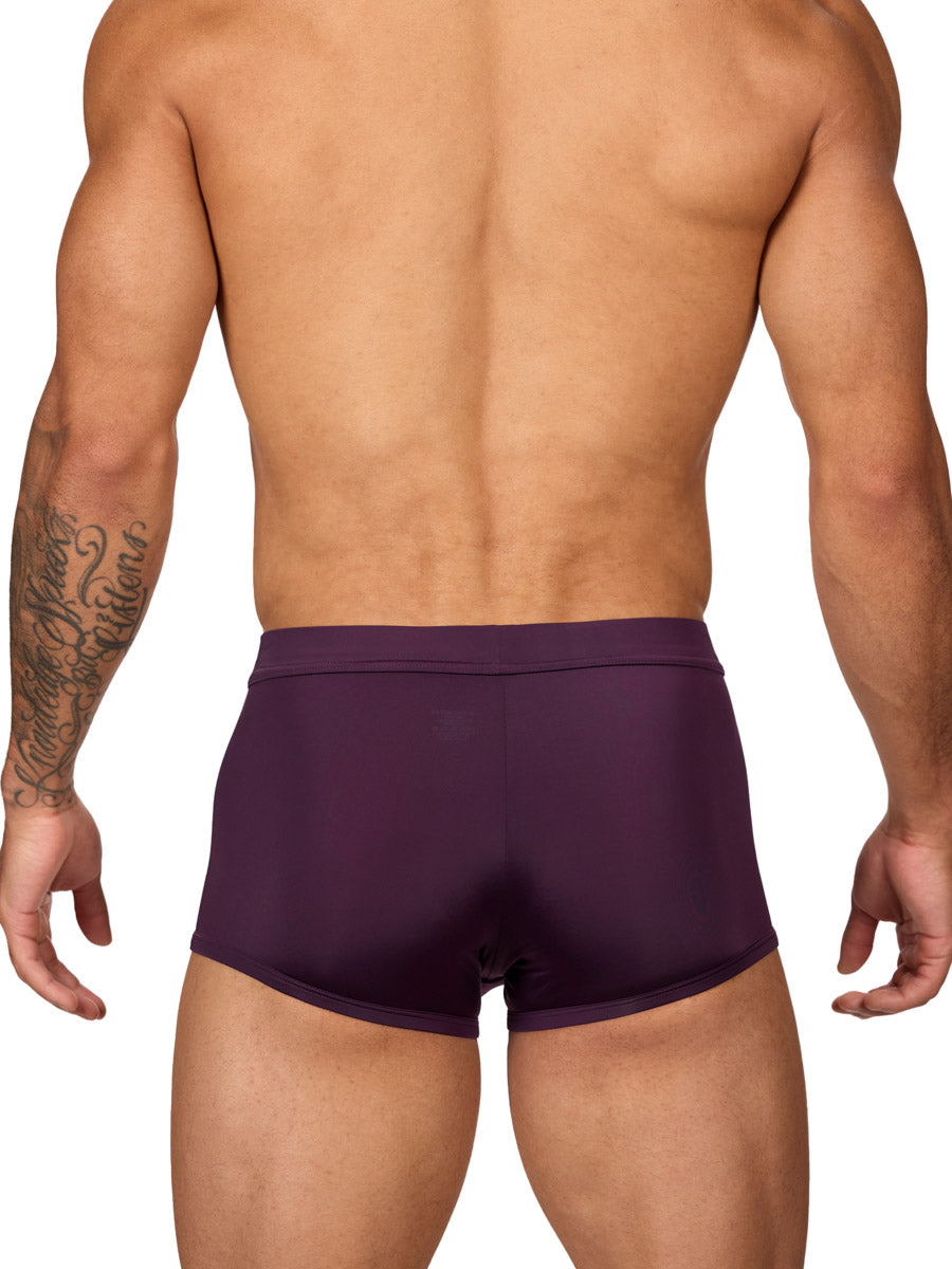 Back view of a muscular male model wearing purple Body Aware boxer shorts