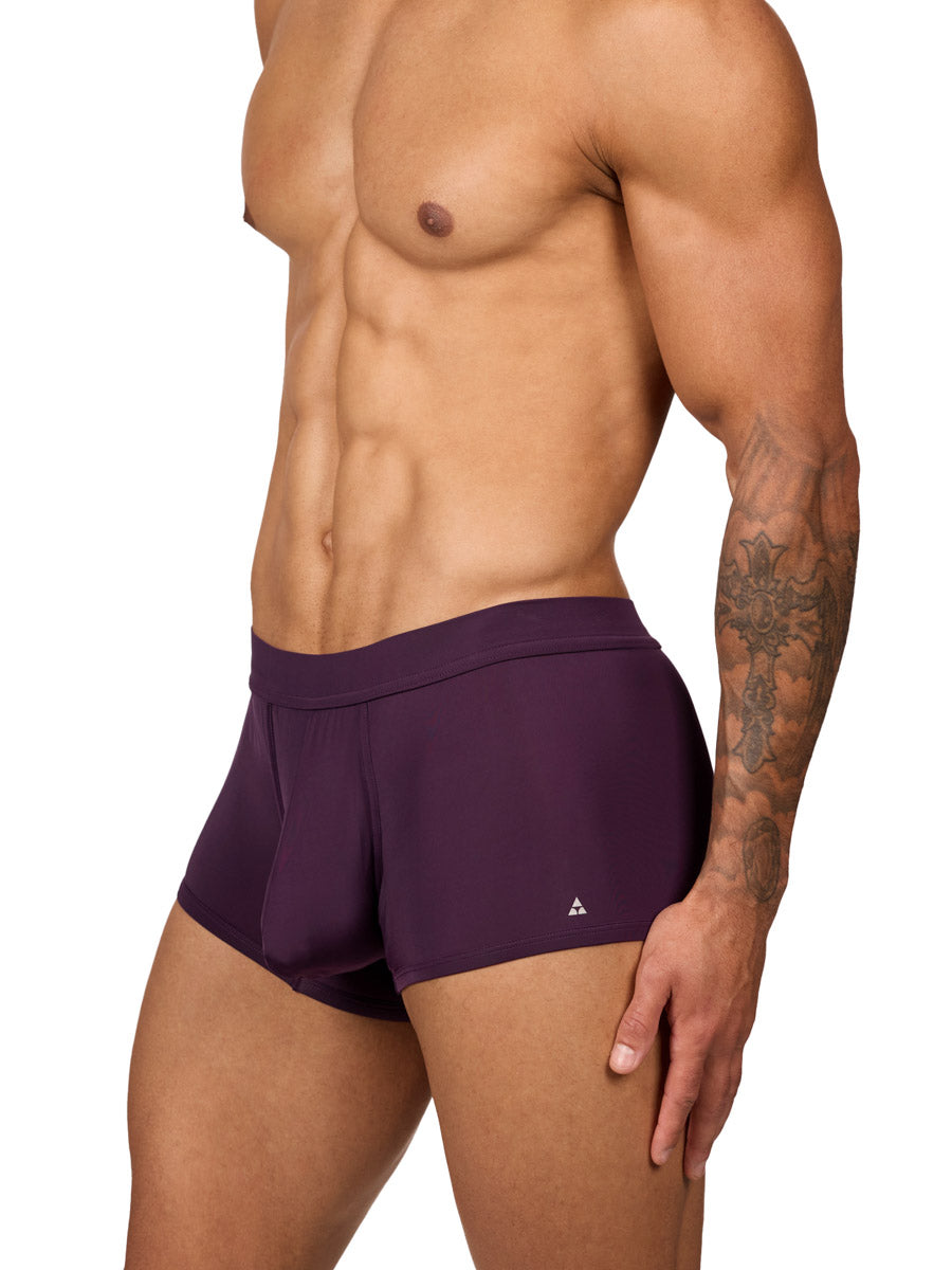 Side view of a muscular male model wearing purple Body Aware boxer shorts