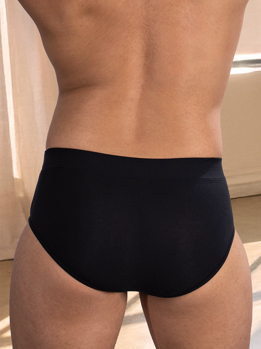 Back view of a man wearing black underwear briefs.