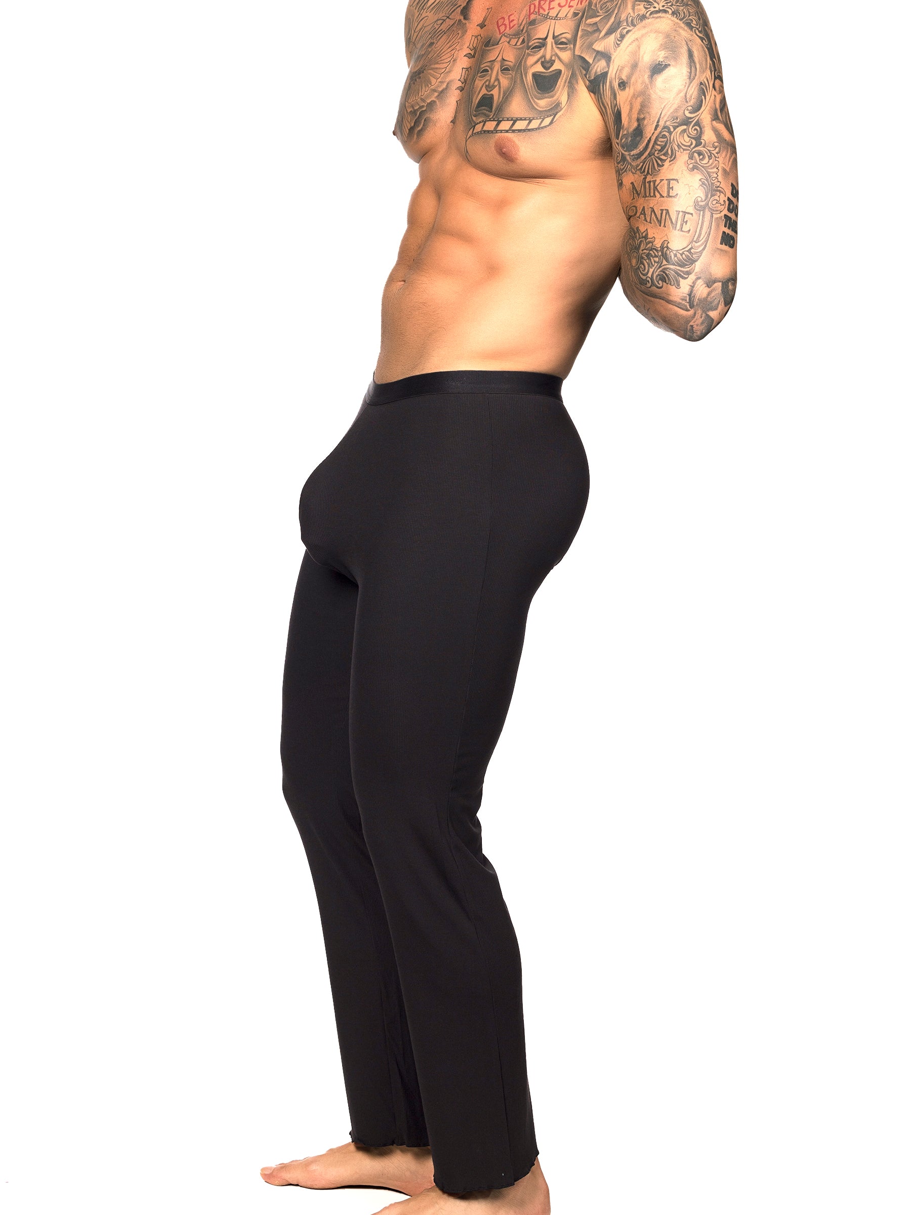 Side view of a male model wearing black Body Aware lounge pants