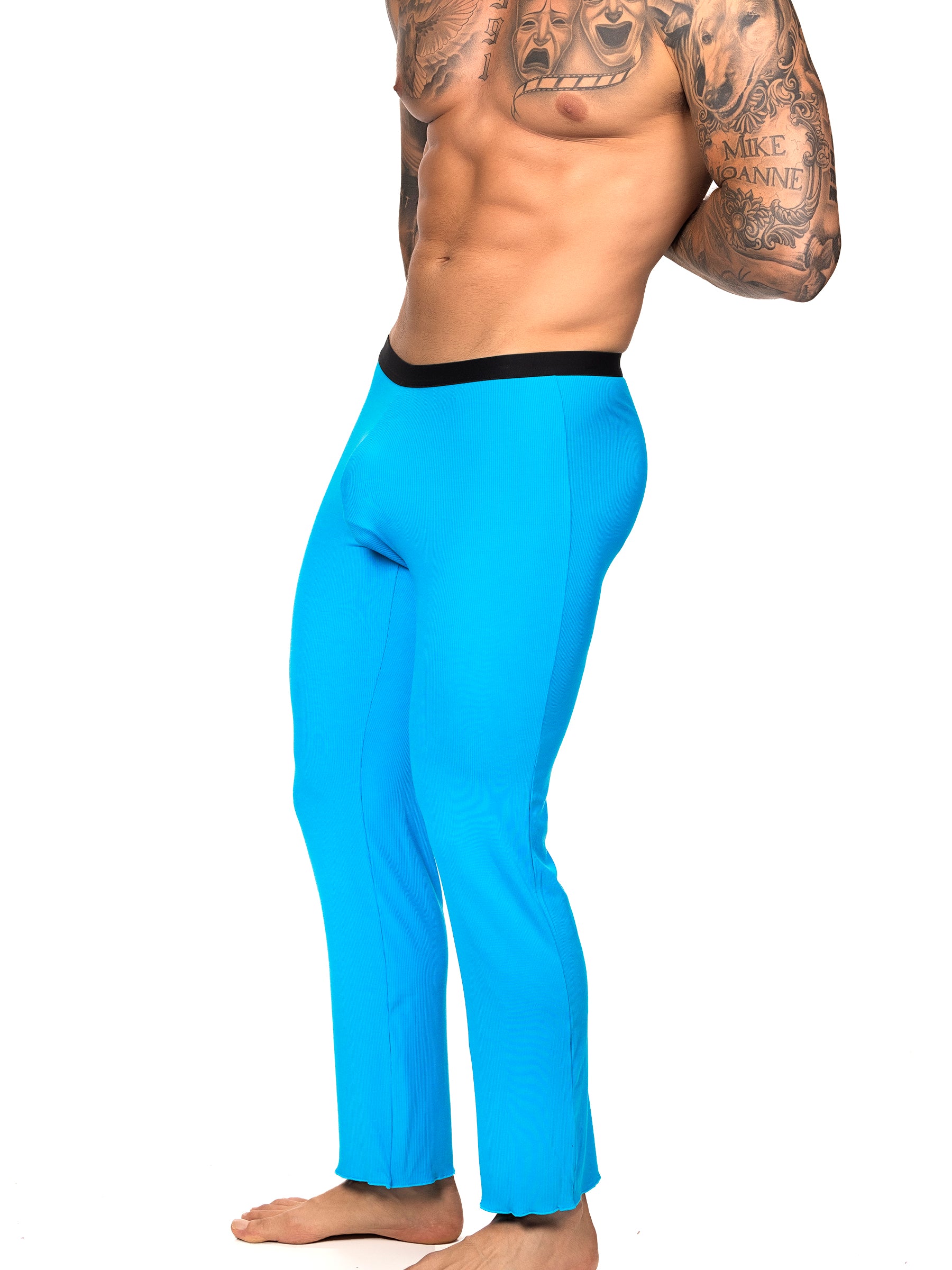 Side view of a male model wearing turquoise Body Aware lounge pants with black waistband