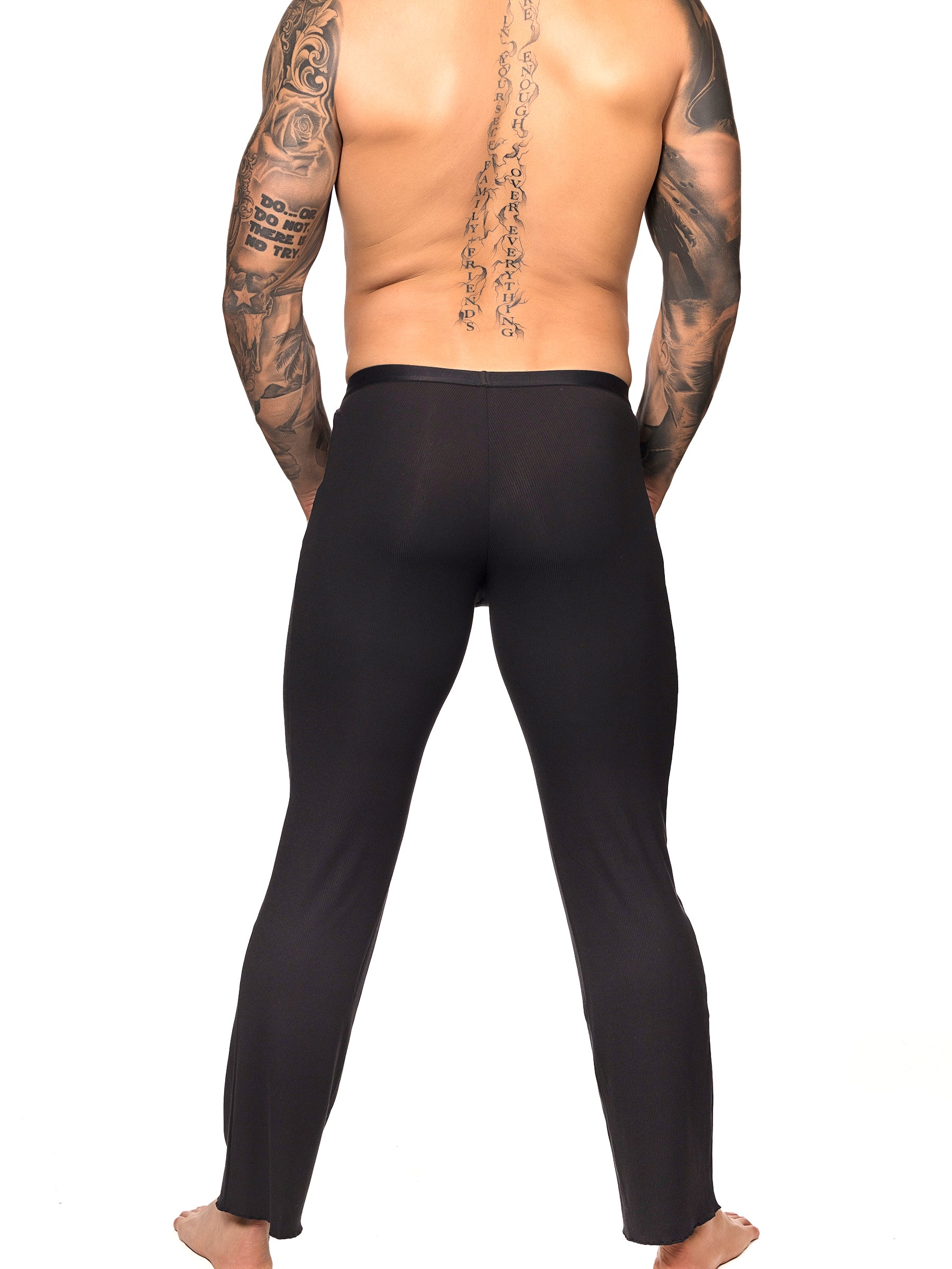 Back view of a male model wearing black Body Aware lounge pants