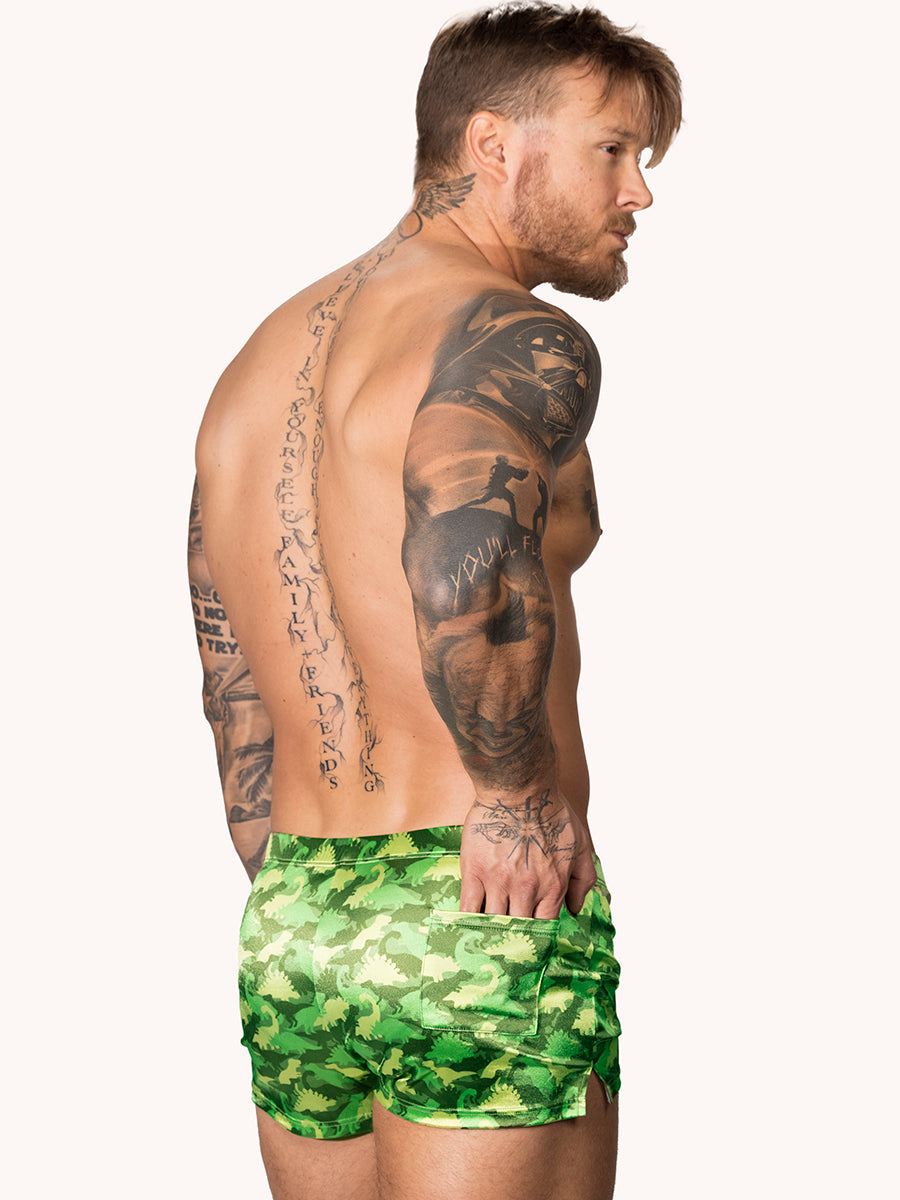 Back view of a male model wearning green Body Aware shorts with a camo pattern