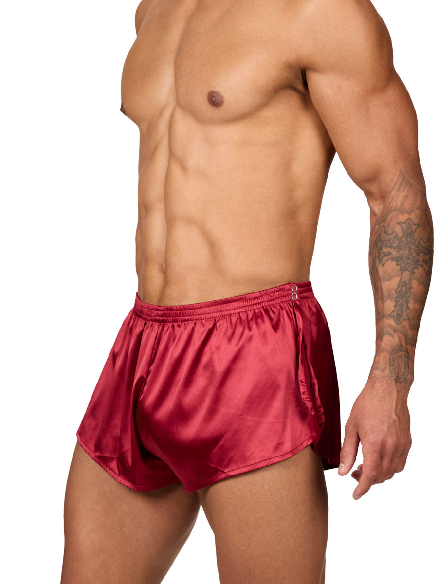 Side view of a male model wearing Body Aware red men's tear away shorts