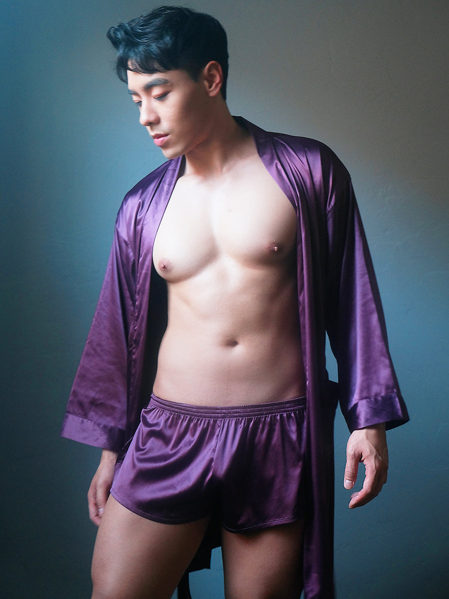 Front view of a male model wearing a purple Body Aware men's robe