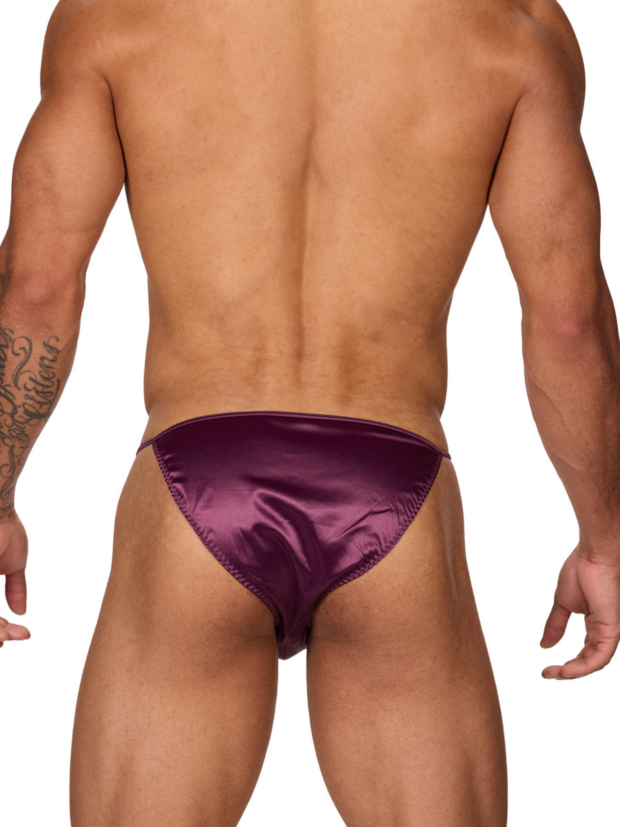 Back view of a male model wearing a Body Aware purple men's bikini brief